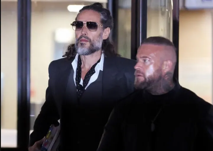 Brand (left) leaves Southwark crown court after Thursday’s proceedings. Photograph: Corey Rudy/Reuters